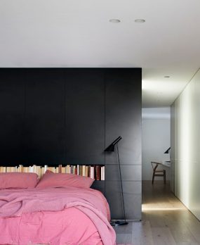 Central Park Road bedroom with black wall and bed with pink linen